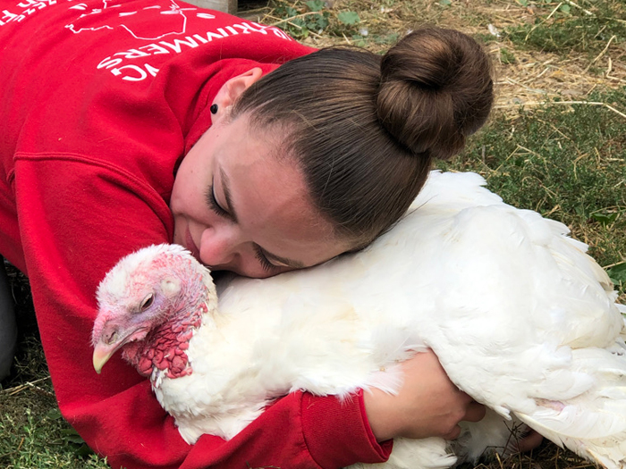 young woman hugging turkey