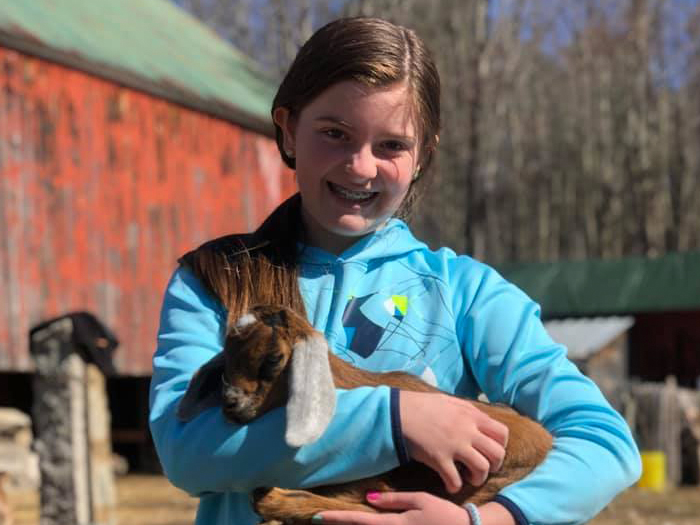girl with baby goat